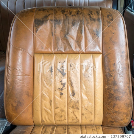 Worn Brown Leather Car Seat with Vertical Lines and Visible Wear and Tear 137299707