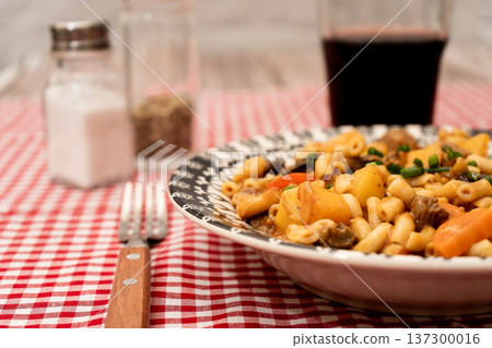 Goulash stew with pasta, vegetables and red wine 137300016