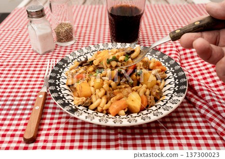 Hearty beef goulash stew with elbow macaroni pasta 137300023