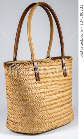 Woven Straw Market Bag with Tan Handles and Detailed Texture on Gray Background 137300233