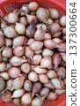 Lot of onions in a red bowl. 137300664