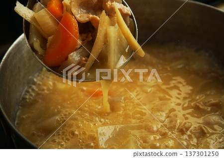 從鍋子裡舀出的豬肉湯食材 137301250