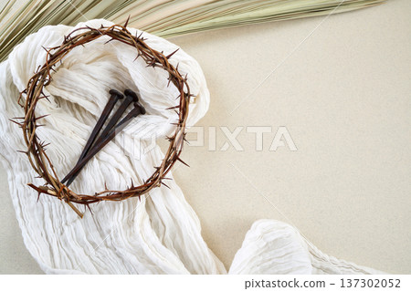 Crown of thorns, nails, cloth, palm leaf representing easter Crown of thorns, nails, cloth, palm leaf representing easter 137302052