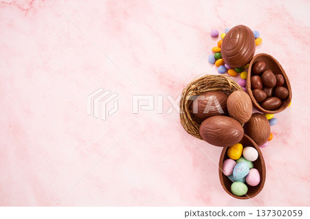 Easter chocolate eggs and sweets on pink background Easter chocolate eggs and sweets on pink background 137302059