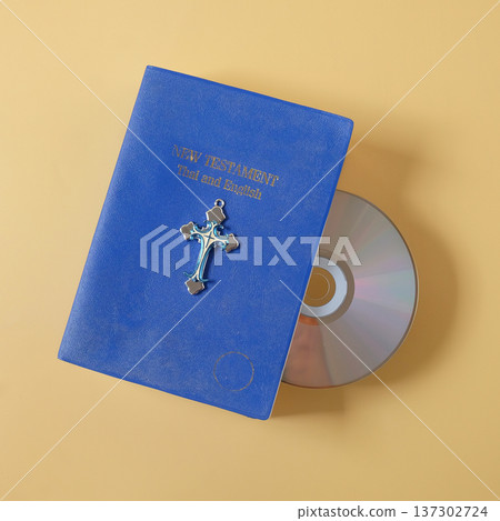 Bible book with CD rom on color background. Bible book with CD rom on color background. 137302724