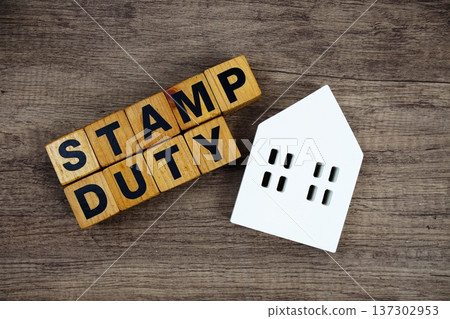 Stamp Duty alphabet letters with house model on wooden background 137302953