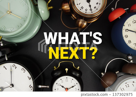 What's Next? text with alarm clock on black background What's Next? text with alarm clock on black background 137302975
