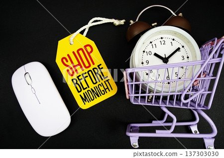 Shop Before Midnight text with price tag, optical mouse, trolly cart and alarm clock on black background, Shopping Online Concept Shop Before Midnight text with price tag, optical mouse, trolly cart and alarm clock on black background, Shopping Online Concept 137303030