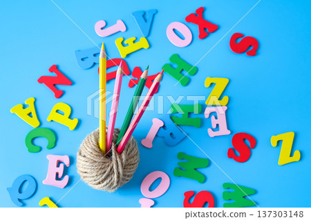 Minimalist photo of a natural jute twine with alphabet letters. 137303148