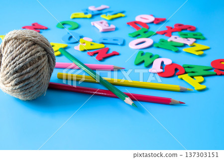 Minimalist photo of a natural jute twine with alphabet letters. Minimalist photo of a natural jute twine with alphabet letters. 137303151