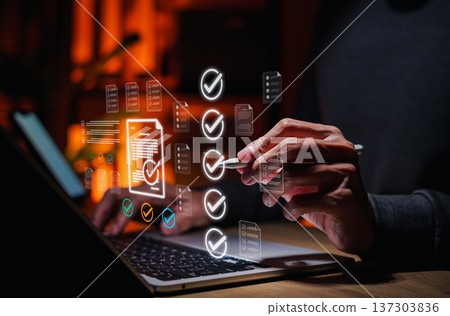 Business professional reviewing digital checklist documents on laptop, approval process, quality control, audit compliance, document verification, data validation and workflow management. Business professional reviewing digital checklist documents on laptop, approval process, quality control, audit compliance, document verification, data validation and workflow management. 137303836