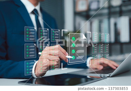 Digital document management concept showing business approval workflow, checklist verification, and compliance review, with professional using laptop and tablet to validate files in office environment 137303853