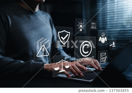 Copyright protection concept. Person using laptop with copyright, legal, security, and compliance icons, representing intellectual property rights, digital content protection and online law management 137303855