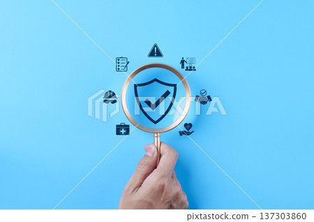 Work safety concept. hand holding magnifying glass over shield check mark icon representing occupational health, risk management, compliance policy, industrial protection, workplace security standards Work safety concept. hand holding magnifying glass over shield check mark icon representing occupational health, risk management, compliance policy, industrial protection, workplace security standards 137303860