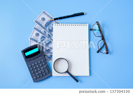 A book note and banknote with pen on color background. A book note and banknote with pen on color background. 137304330