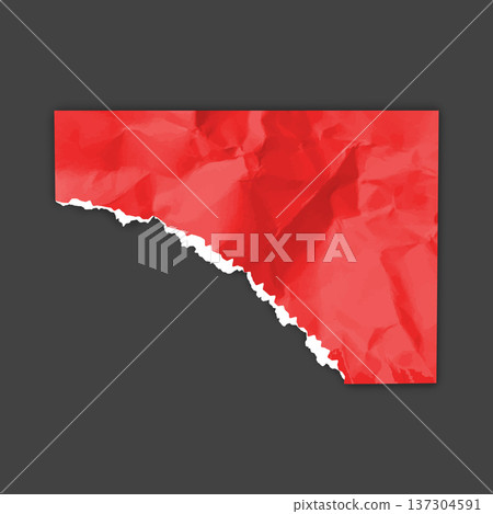 A corner torn piece of red, crumpled paper on an isolated black background. 137304591