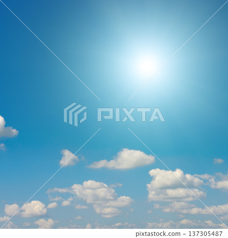 Sunny sky with glowing sunlight and fluffy white clouds on a calm weather day 137305487