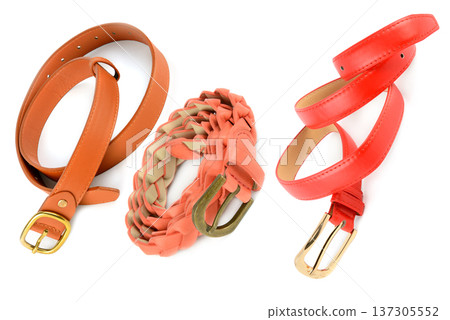 Three fashionable colorful waist belts in orange, coral, and red. Three fashionable colorful waist belts in orange, coral, and red. 137305552