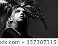 Woman wearing feather headdress looking up monochrome 137307315