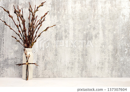 Delicate willow branches in a vase on an elegant kitchen table, abstract spring floral arrangement. Easter card and still life, design template with space for text and festive Easter banner, Delicate willow branches in a vase on an elegant kitchen table, abstract spring floral arrangement. Easter card and still life, design template with space for text and festive Easter banner, 137307604