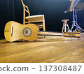 A handcrafted chitarra battente, a traditional Italian instrument, rests on the stage floor. 137308487