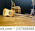 A handcrafted chitarra battente, a traditional Italian instrument, rests on the stage floor. 137308488