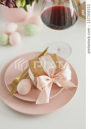 Easter Table Setting with Gift Box, Decorated Eggs, Wine Glass and Tulips. Festive Spring Lifestyle Easter Table Setting with Gift Box, Decorated Eggs, Wine Glass and Tulips. Festive Spring Lifestyle 137308553