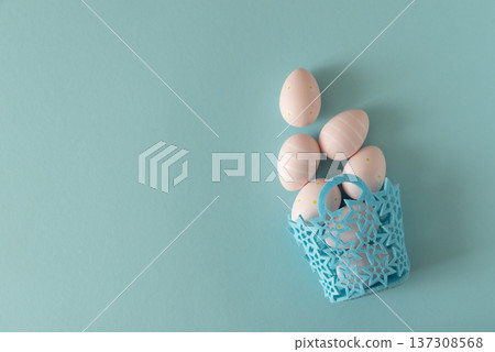 Basket with Pastel Pink Easter Eggs on Blue Background. Minimal Festive Composition Basket with Pastel Pink Easter Eggs on Blue Background. Minimal Festive Composition 137308568
