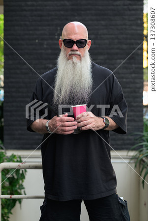 Bald Man with Long White Beard Holding Coffee Outdoors Bald Man with Long White Beard Holding Coffee Outdoors 137308607