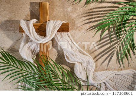 Wooden christian cross with white shroud and palm fronds Wooden christian cross with white shroud and palm fronds 137308661