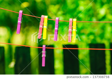 Clothes pegs on line outdoor. Housework 137308738