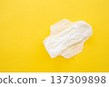 Women's sanitary napkin on a yellow background close-up 137309898