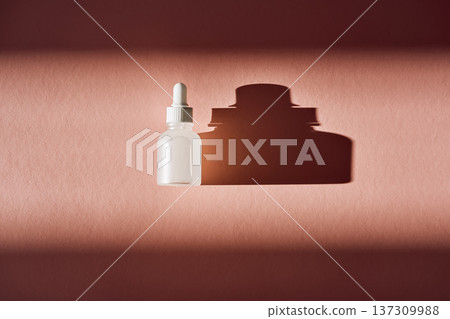 Serum bottle casting shadow on pink background 137309988