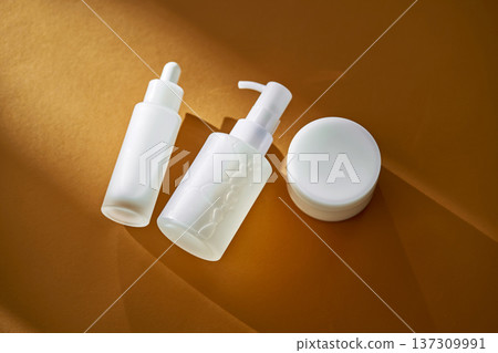 White skincare products on brown background with shadows White skincare products on brown background with shadows 137309991