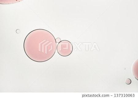 Pink oil drops floating in water forming an abstract liquid background Pink oil drops floating in water forming an abstract liquid background 137310063