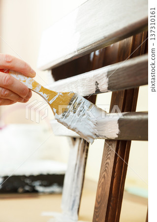 Person renovating wooden hanger 137310161