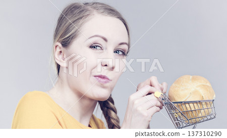 Woman holding shopping cart with bread Woman holding shopping cart with bread 137310290