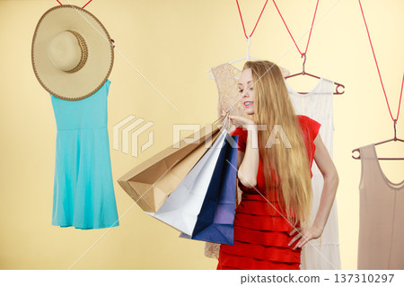 Woman in shop picking clothes, sale concept 137310297