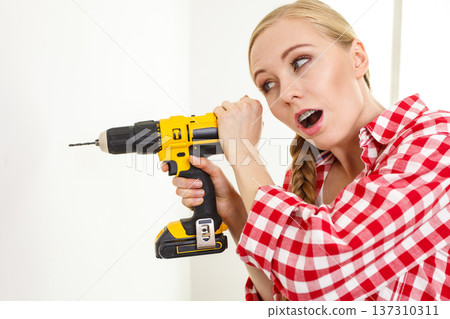 Woman having troubles using drill 137310311