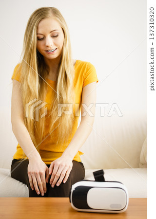 Happy young woman next to VR Happy young woman next to VR 137310320