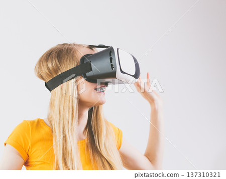 Girl wearing virtual reality goggles. Girl wearing virtual reality goggles. 137310321
