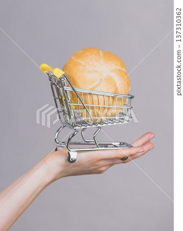 Woman holding shopping cart with bread 137310362
