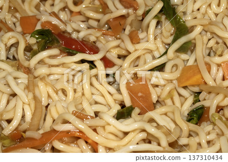 A Close up of delicious fried noodles dinner with vegetables A Close up of delicious fried noodles dinner with vegetables 137310434