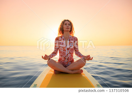 Young woman walking on sup board by the sea during summer vacation Young woman walking on sup board by the sea during summer vacation 137310506