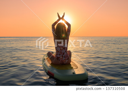 Young woman walking on sup board by the sea during summer vacation 137310508