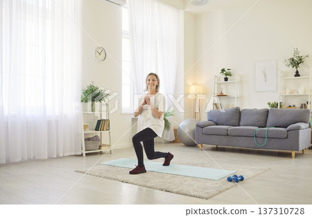 Knee exercise for balance at mat, fitness, senior sporty woman, old yoga at home alone 137310728