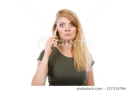 Angry young woman talking on phone Angry young woman talking on phone 137310764
