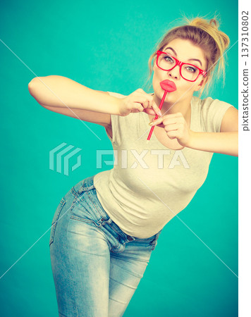 Happy woman holding fake lips on stick Happy woman holding fake lips on stick 137310802