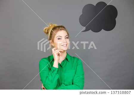 Happy woman holding black thinking bubble Happy woman holding black thinking bubble 137310807