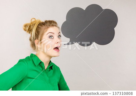 Woman holding black thinking bubble 137310808